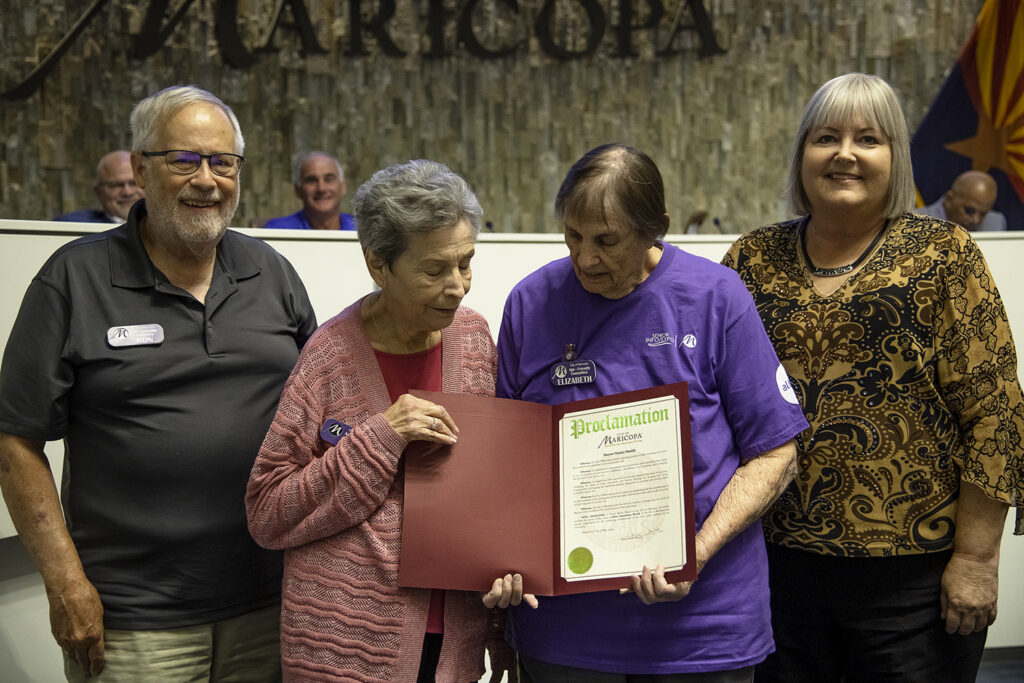 From left: Ron Smith, Joan Koczor, Elizabeth Howell and Mayor Nancy Smith stand with the Proclamation for Older Americans Month during a city council meeting on May 2, 2023. [Monica D. Spencer]