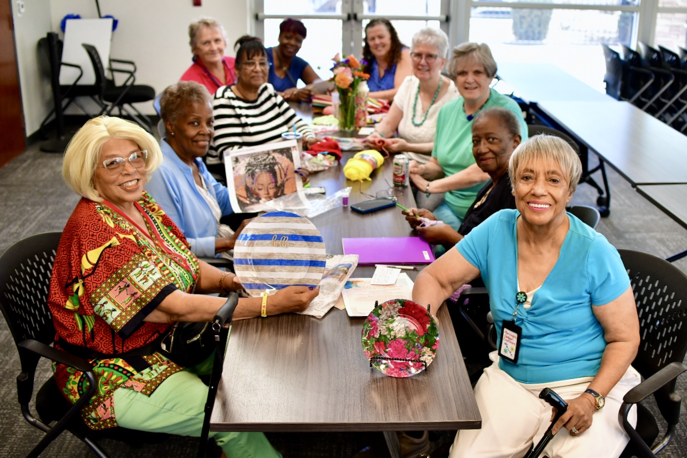 Some members of the Maricopa Golden Crafters group sit with their projects at a table inside Global Water Resources on July 28, 2025. [Monica D. Spencer]