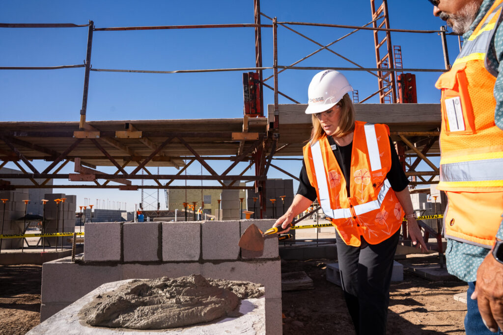 Superintendent Dr. Tracey Lopeman applies cement during the cornerstone ceremony in Sorrento on Oct. 29, 2025. [David Iversen]