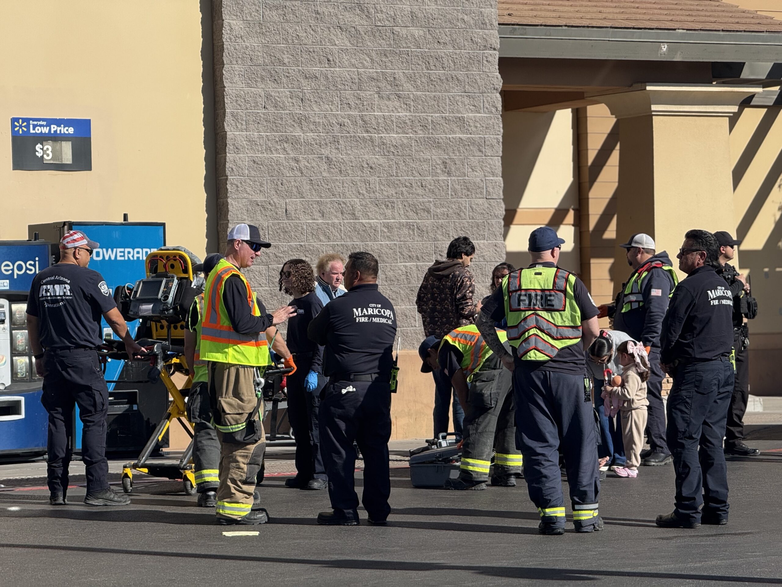 Maricopa Fire Medical first responders evaluate a woman after she was hit by a truck while crossing a marked crosswalk in the Walmart parking lot in Maricopa. Dec. 15, 2025. [David Iversen]