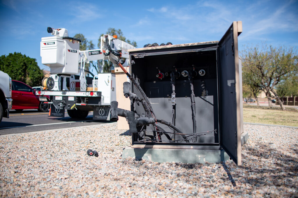 Covered in soot and showing smoke lines, a transformer box in Tortosa undergoes repairs on Feb. 19, 2026. [Monica D. Spencer]