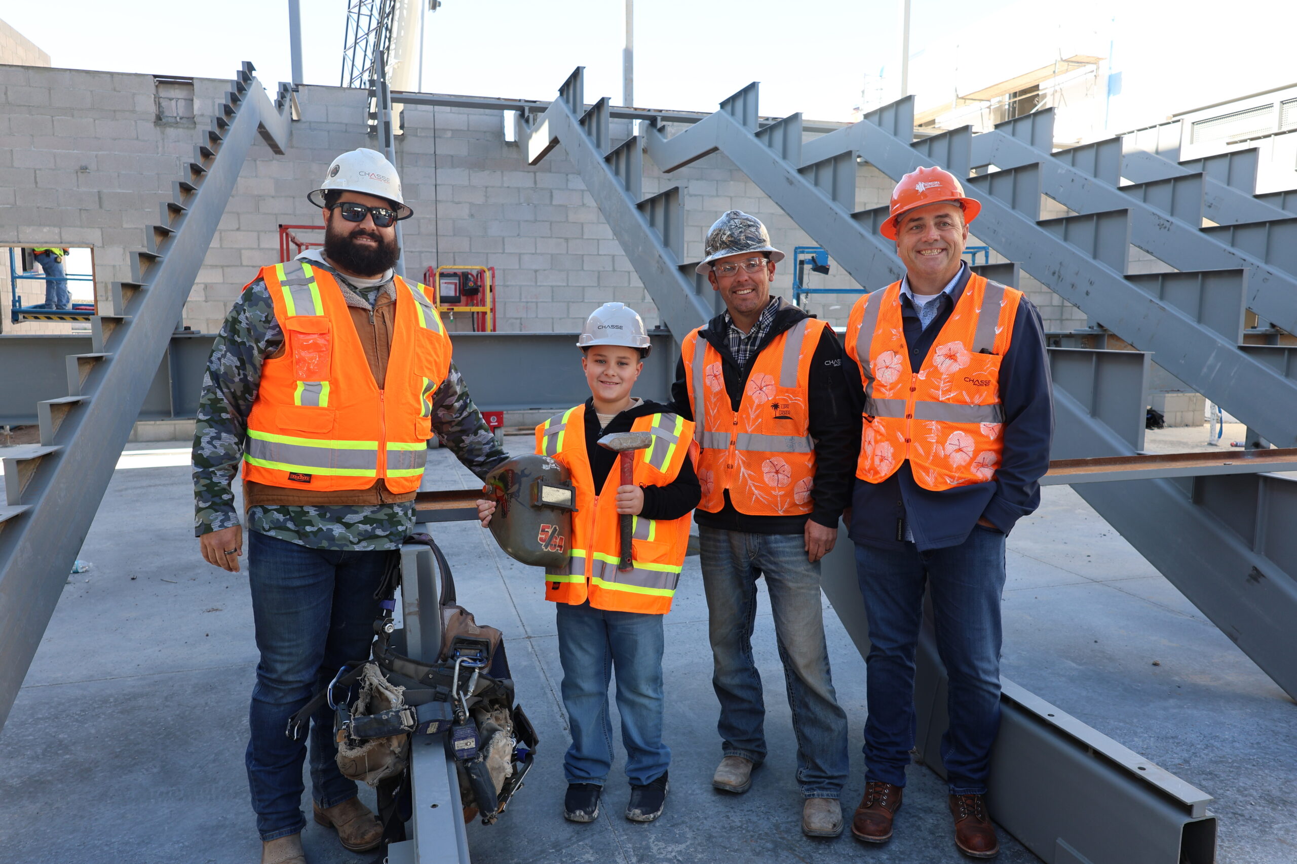 Future AFIA student posing with members of CHASSE building team
