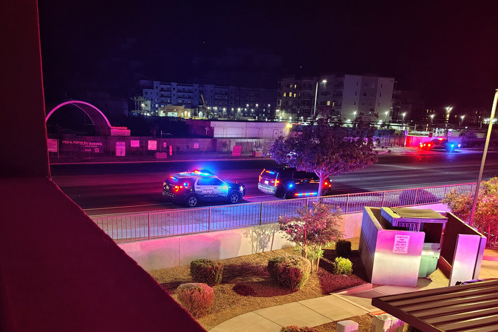 Seen from the view of a resident's patio, police arrive at the scene of a reported shooting at Horizon at the Wells apartments on Shea Way on April 10, 2026. [Submitted]