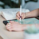 An artist draws on a tablet in this undated photo. [Michael Burrows/Pexels]