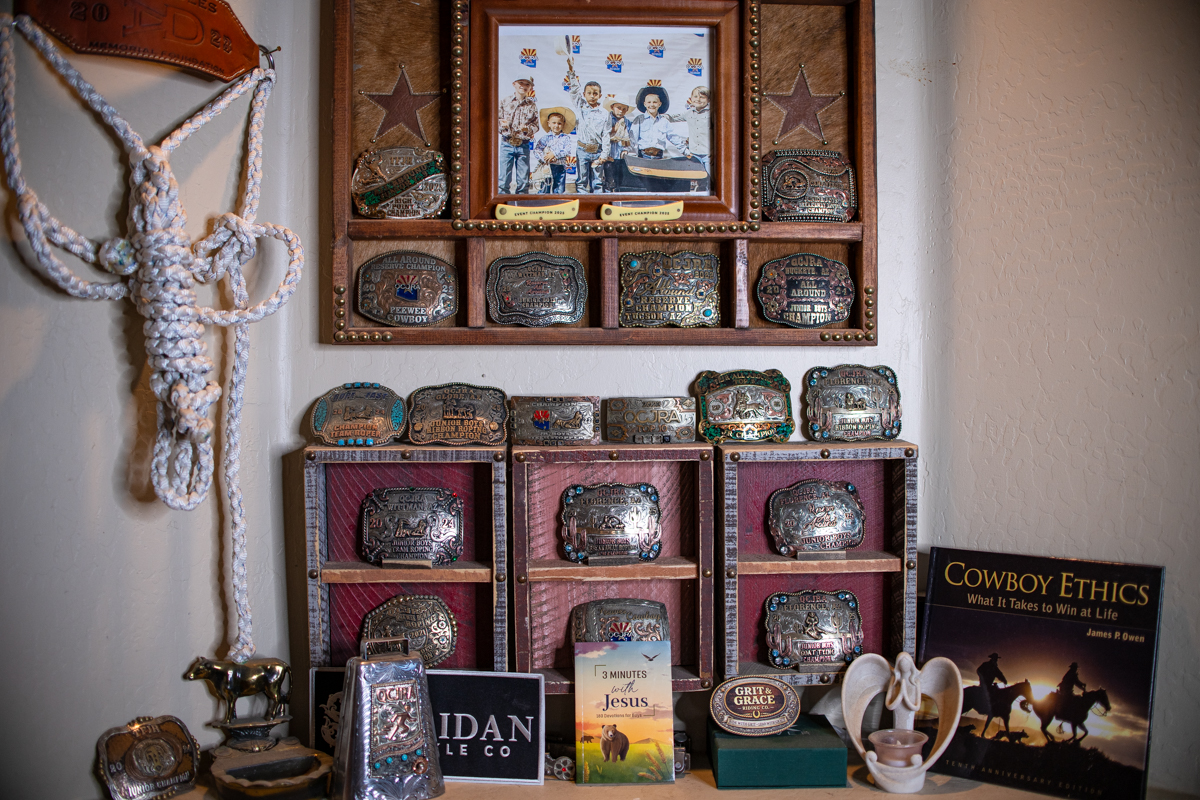 RJ Ruiz's belt buckles, books and awards sit on display in his family's Hidden Valley home on May 9, 2026. [Monica D. Spencer]