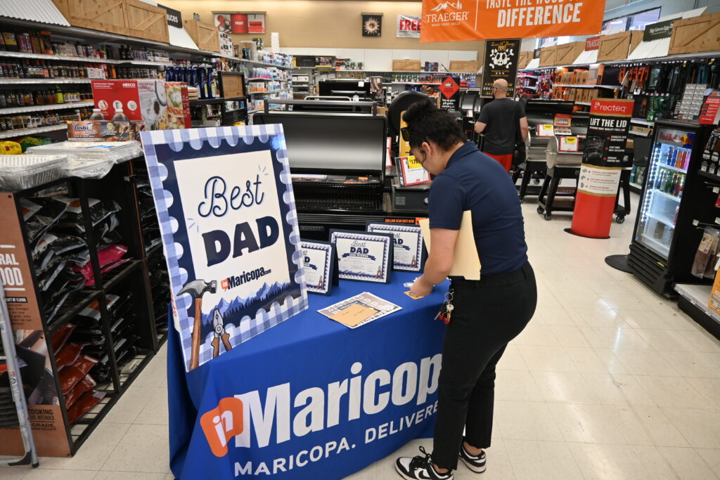 InMaricopa’s Erik Paramo arranges the prizes. [Staff]