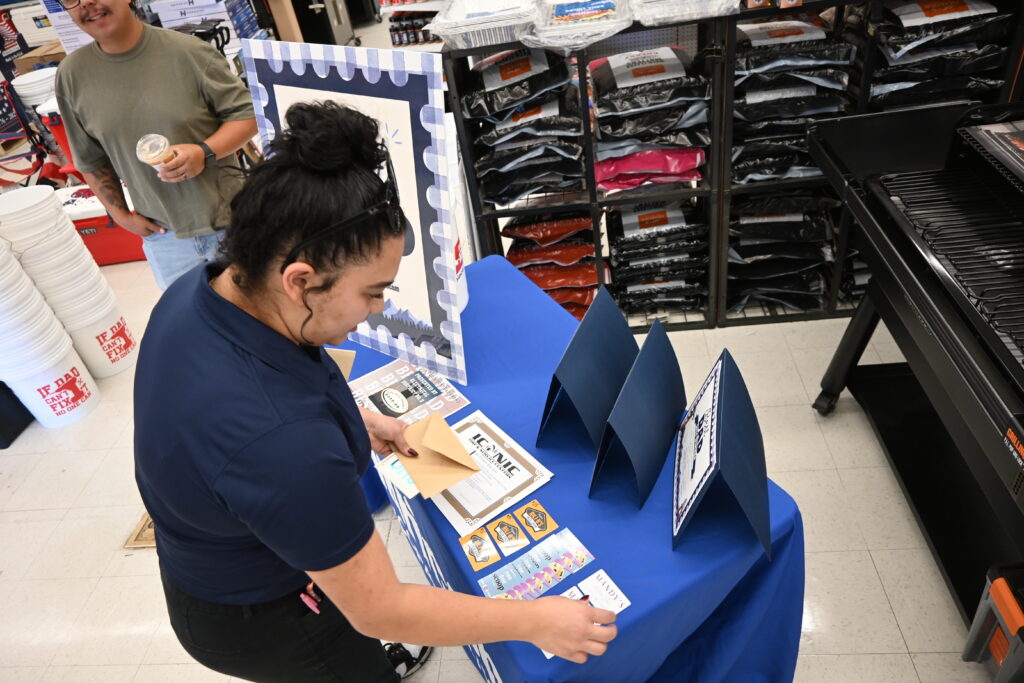 InMaricopa’s Erika Paramo arranges the prizes. [Staff]