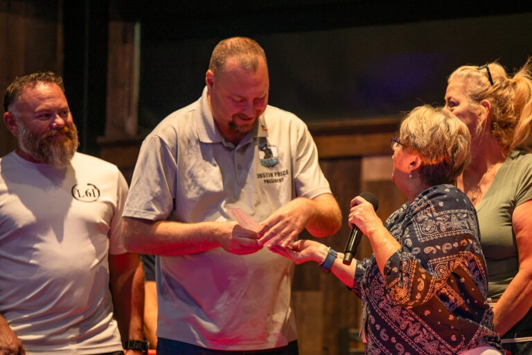 Veterans in Need Board Member Justin Price accepts a donation check from Maricopa Moose and Duke's Roadhouse on Oct. 19, 2026. [Monica D. Spencer]