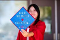 Hana Iwashita holds a decorated graduation cap in front of Maricopa High School on May 22, 2026. [Monica D. Spencer]