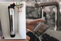 A photo of a custom-made Glacier Springs Water system, layered over a photo of person washing a cup in a sink. [Glacier Springs Water, Cotton Bro Studio]
