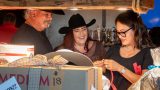 Guests laugh during the Dirty Boots & Dollars Fundraiser at Duke's Roadhouse on June 27, 2026. [Ryan Tafoya]