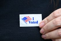 A voter showed off her voting sticker outside Maricopa Community Center on July 21, 2026. [Karen Bartunek]
