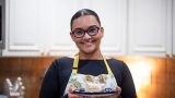 Senita resident Erika Paramo stands with a pan of tres leches cake. [Monica D. Spencer]