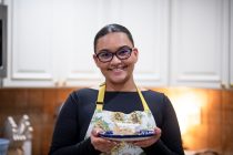 Senita resident Erika Paramo stands with a pan of tres leches cake. [Monica D. Spencer]