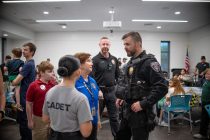 An officer, cadet and police volunteer speak during a Cops and Cones event on Aug. 26, 2026. [Monica D. Spencer]