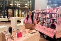 Owner Elicia Gabriela Estrada next to Graciela's Mobile Books. [Submitted]