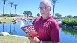 Tom Schuman stands with a copy of his book "Why Not Us?" in Province on Sept. 17, 2026. [Karen Bartunek]