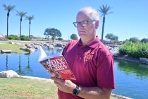 Tom Schuman stands with a copy of his book "Why Not Us?" in Province on Sept. 17, 2026. [Karen Bartunek]