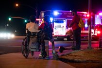 Pedestrians on John Wayne Parkway and Edison Road watch as Maricopa Fire and Police investigate a crash involving a pedestrian on Sept. 18, 2026. [Monica D. Spencer]