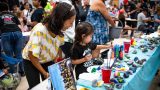 Janelle Gomez watches 4-year-old Anela paint rocks during Kids Day Maricopa at Maricopa Wells Middle School on Sept. 19, 2026. [Monica D. Spencer]