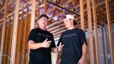 Danny and Parker Hunsaker, co-owners of the upcoming Back Nine indoor golf simulator, stand inside the building under construction on Sept. 22, 2026. [Monica D. Spencer]