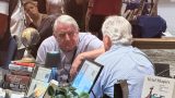 Pete A. Rathfelder and Roger Evans deep in conversation at the "Merlot and Manuscripts" event on Sept. 25, 2026. [Karen Bartunek]