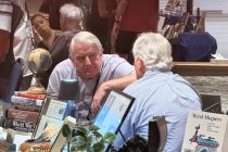 Pete A. Rathfelder and Roger Evans deep in conversation at the "Merlot and Manuscripts" event on Sept. 25, 2026. [Karen Bartunek]