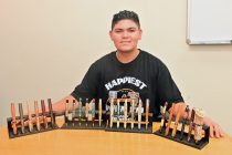 Julian Reyes, 15, stands with a collection of his handmade pens on Aug. 29, 2026. [Karen Bartunek]