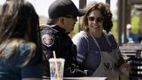 A woman speaks with an officer during Maricopa Police Department's Coffee with a Cop event at Cold Beers & Cheeseburgers on April 29, 2023. [Monica D. Spencer]