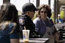 A woman speaks with an officer during Maricopa Police Department's Coffee with a Cop event at Cold Beers & Cheeseburgers on April 29, 2023. [Monica D. Spencer]